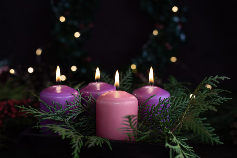 Three purple and one pink advent candles in Christmas eve, catholic symbol
