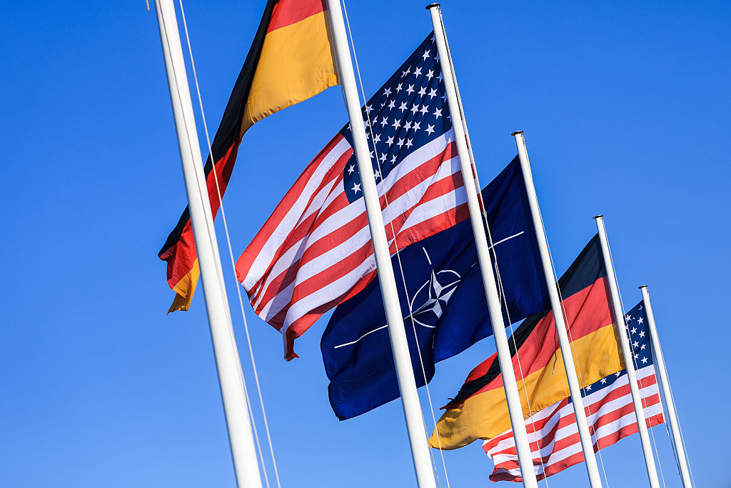 SCHOENEFELD, GERMANY - NOVEMBER 07: The flags of NATO, Germany and the USA are seen on November 07, 2025 in Berlin, Germany after the Bundeswehr's first P-8A Poseidon maritime reconnaissance plane arrives. The P-8A will replace the German Navy's aging P-3 Orions and mostly conduct maritime surveillance over the Baltic Sea and the North Sea. (Photo by Maja Hitij/Getty Images)