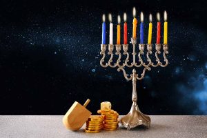Hanukkah Festival of Lights word search puzzle featuring candles, a menorah, dreidel, and festive blue and gold holiday designs.