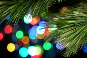 Christmas Tree Lights Background. A Christmas tree branch with glowing lights in the background