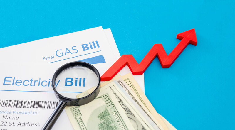 Rising cost of living. Electricity and gas bills and US dollars banknotes. Household cost increase concept