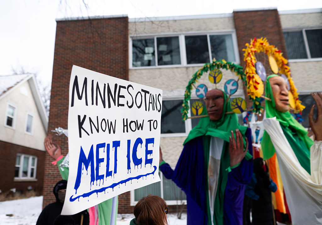 A person holds a sign that reads "Minnesotans Know How to Melt ICE" as people gather for a march to memorialize Renee Nicole Good and against the influx of federal agents in the city on January 10, 2026 in Minneapolis, Minnesota.