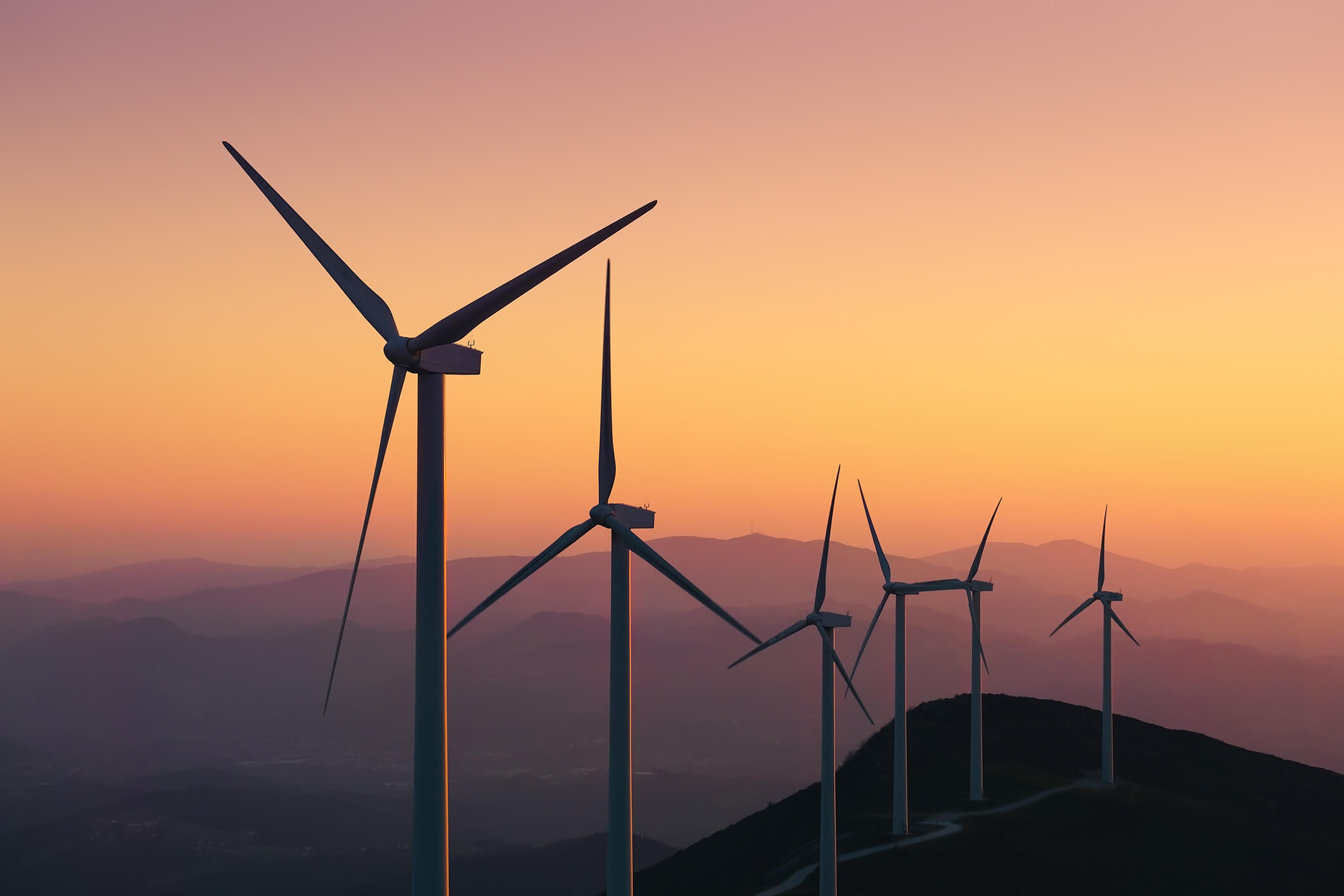 Renewable energy with wind turbines at sunset