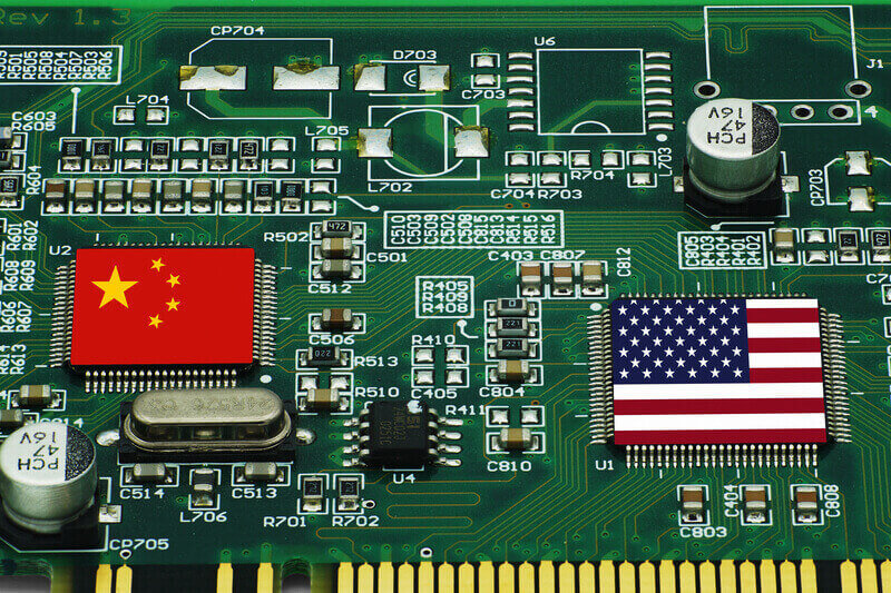 Chinese and American flags on AI GPU processors. Concept of technological competition between the USA and China.