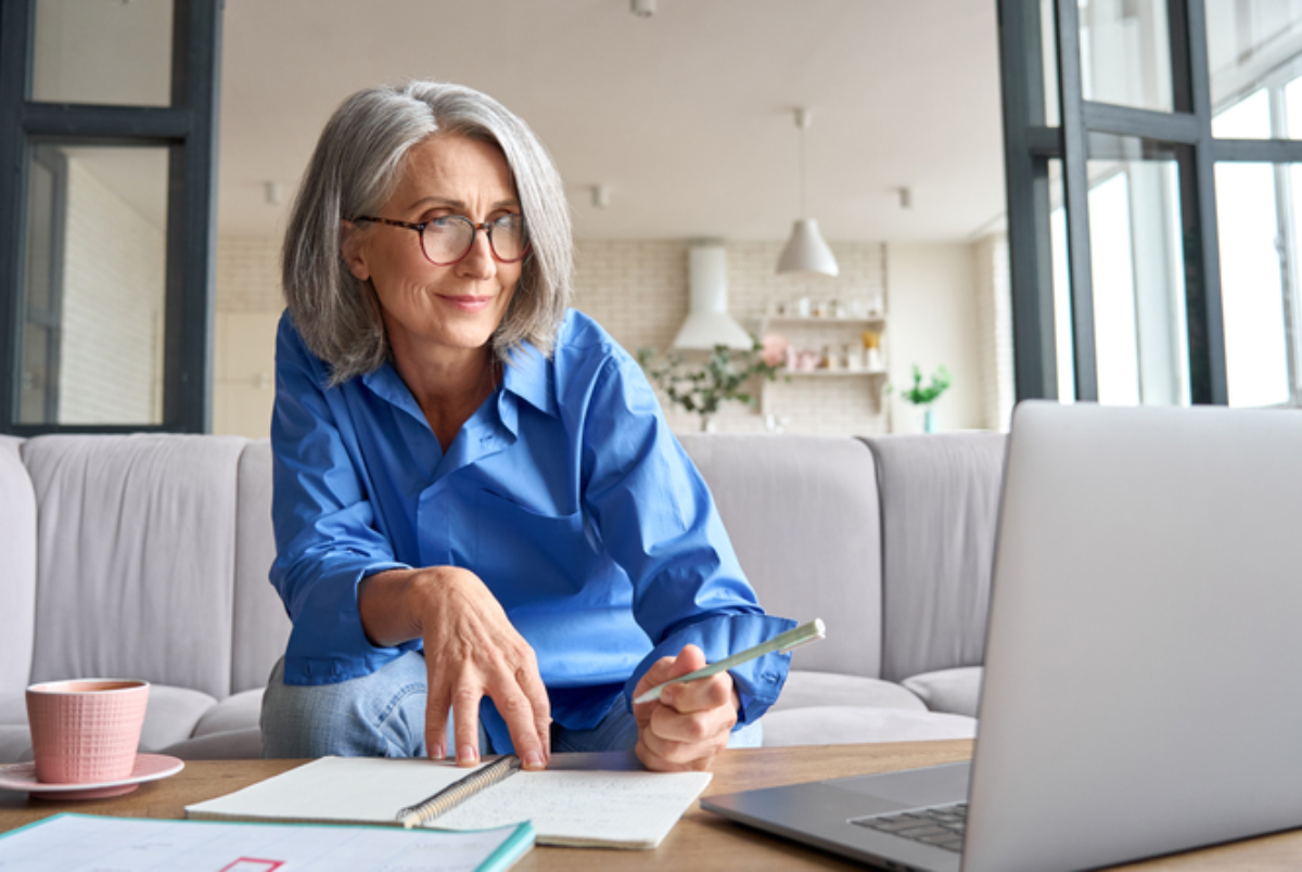 Senior woman going back to school in retirement, online learning.