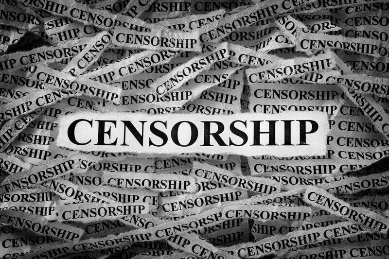 Strips of newspaper with the word Censorship typed on them. Black and White. Close up