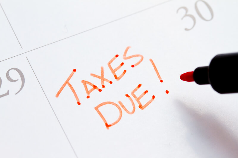 Taxes due written on calendar with red pen