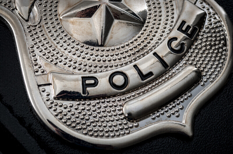 Cops and police officer badge with macro close up on the `police` text of a cop badge