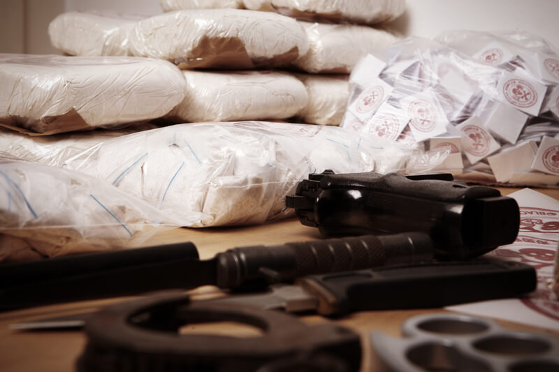 Drug criminality. Drug packages, raw opium, drug dozens and weapons seized by police