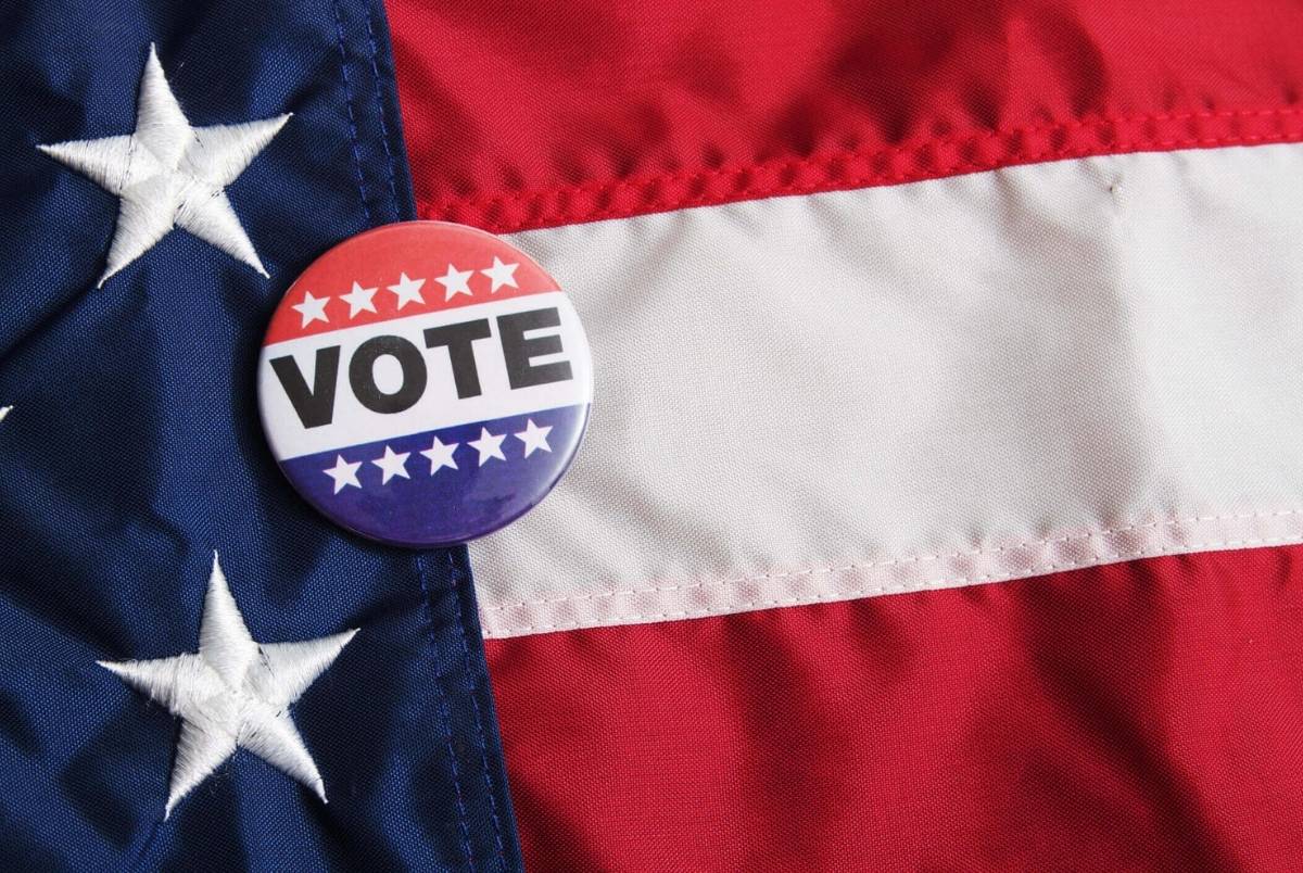USA Voting Pin on Flag. A USA voting pin on an American flag with nobody.