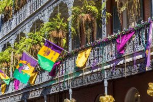 A Mardi Gras parade decoration on a historic balcony in New Orleans, Louisiana.