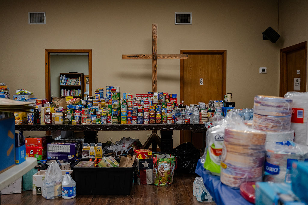 HUNT, TEXAS - JULY 6: Food for those in need sit on tables in front of a large cross at the Hunt Baptist Church on July 6, 2025 in Hunt, Texas. Heavy rainfall caused flooding along the Guadalupe River in central Texas with multiple fatalities reported. (Photo by Jim Vondruska/Getty Images)
