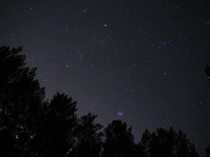 Night sky stars Auriga and Taurus constellation pleiades open star cluster.