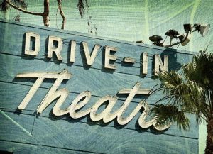 A vintage sign for a drive-in theater, an iconic American entertainment venue that peaked in popularity during the mid-20th century.