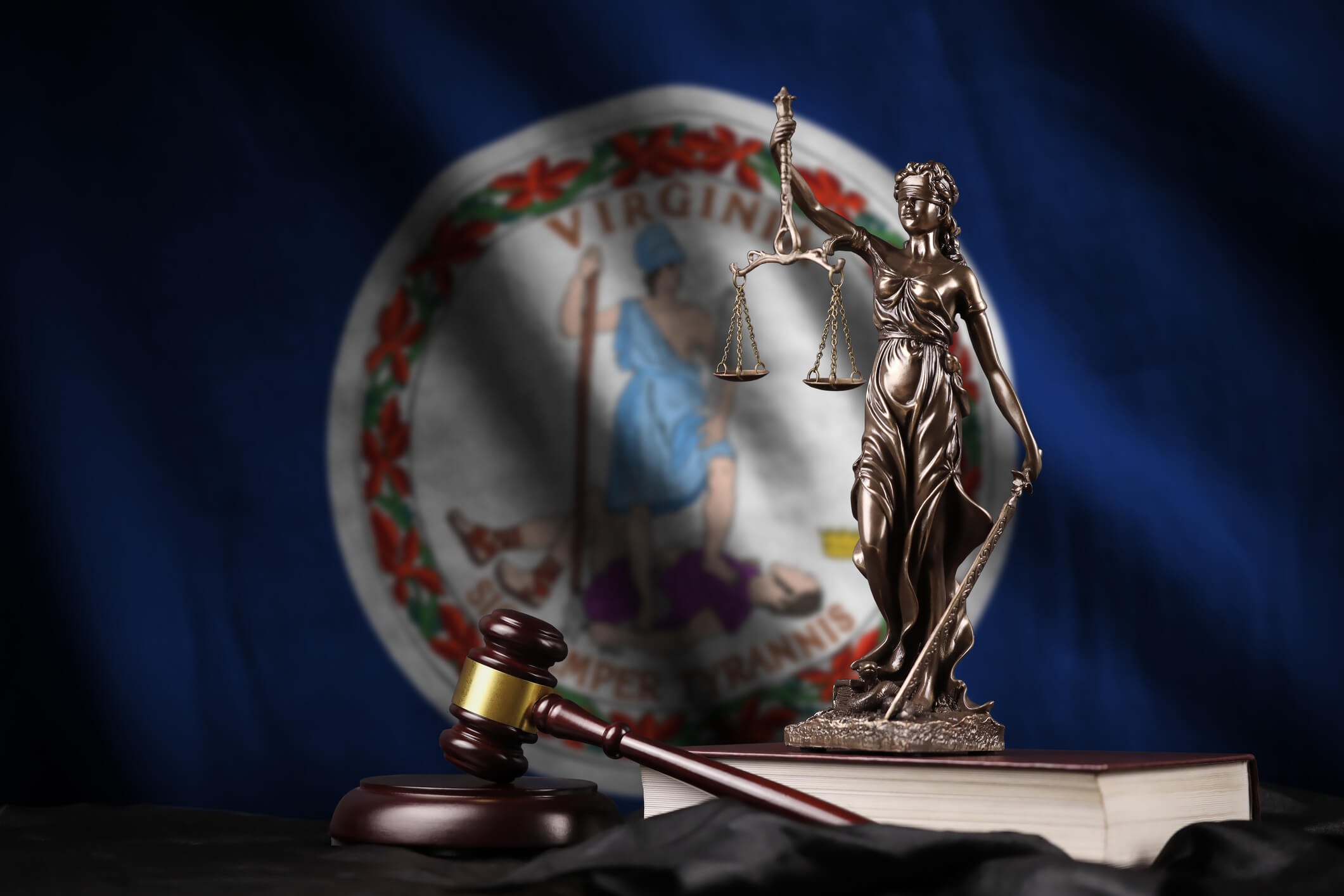 Virginia US state flag with statue of lady justice, constitution and judge hammer on black drapery. Concept of judgement and punishment
