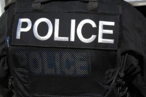 POLICE officer logo on SWAT officers vest. A large POLICE logon on the rear of a SWAT officers tactical vest.