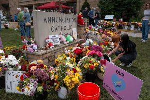 MINNEAPOLIS, MINNESOTA - AUGUST 29: People visit a growing memorial outside of Annunciation Catholic Church on August 29, 2025 in Minneapolis, Minnesota. On August 27 a gunman fired through the stained-glass windows of the church while students were sitting in pews during a Catholic school Mass, killing two children and injuring at least 17 others. The gunman reportedly died at the scene from a self-inflicted gunshot wound, according to police. (Photo by Scott Olson/Getty Images)