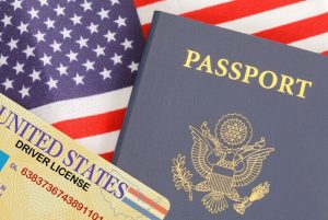 Passport License Flag. American Passport Close Up With Drivers License on Top of USA Flag.