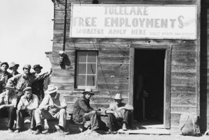 Unemployed men waiting outside the California State Employment Service office at Tulelake, Siskiyou County, California, September 1939. (Photo by Dorothea Lange/FPG/Hulton Archive/Getty Images)