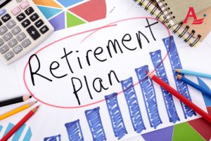 Retirement plan, pension fund growth planning. The words Retirement Plan written on a hand drawn bar chart surrounded by pencils, books and calculator.