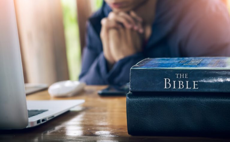 financial stress, faith in god - man praying