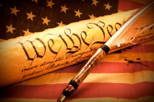 US Constitution - We The People. Old fashionet American Constitution - We the people with USA Flag.
