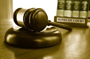 Judge`s Supreme Court gavel with law books