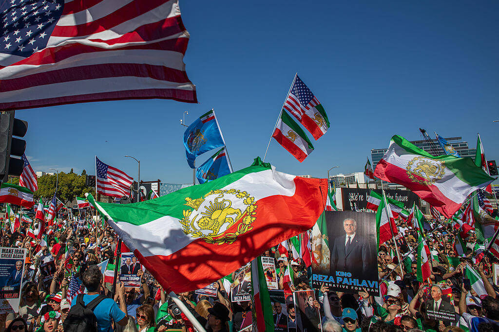 People wave Iranian pre-1979 Islamic Revolution, and American flags while members of the Iranian community celebrate in front of the Federal Building on March 1, 2026 in Los Angeles, California. U.S.