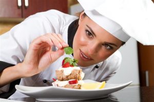 A professional chef plating a dish.