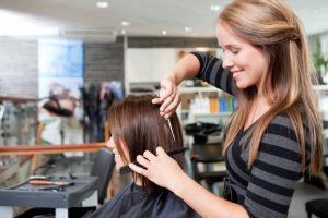 Hair stylist cutting someone hair.