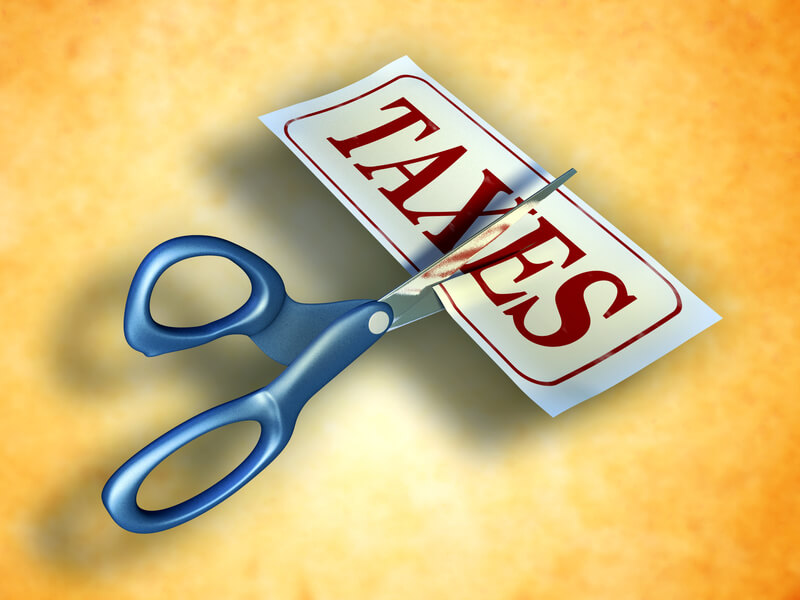 Tax cut. Some scissors are cutting a piece of paper with the word taxes. Digital illustration. Included clipping path allows to isolate objects from background.