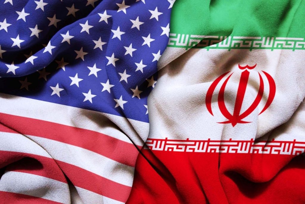 Closeup of USA and Iran silk flags in the studio. Conflict concept.