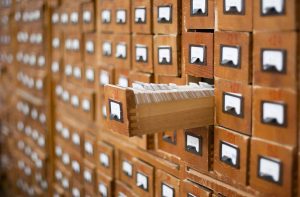 A vintage library card catalog, a system used to organize and locate books within a library before the widespread adoption of digital databases.