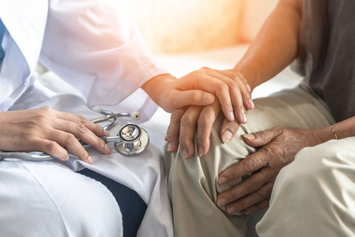Parkinson`s disease patient, Arthritis hand and knee pain or mental health care concept with geriatric doctor consulting examining elderly senior aged adult in medical exam clinic or hospital