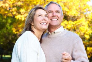 Happy elderly seniors couple in park