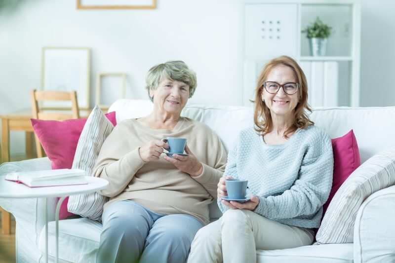Woman with elderly mother. Middle-aged women spending time with her elderly mother