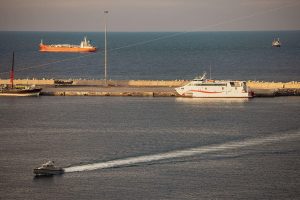 A police speed boat patrols the port as oil tankers and high speed crafts sit anchored at Muscat Anchorage near the Strait of Hormuz on March 30, 2026 in Muscat, Oman.
