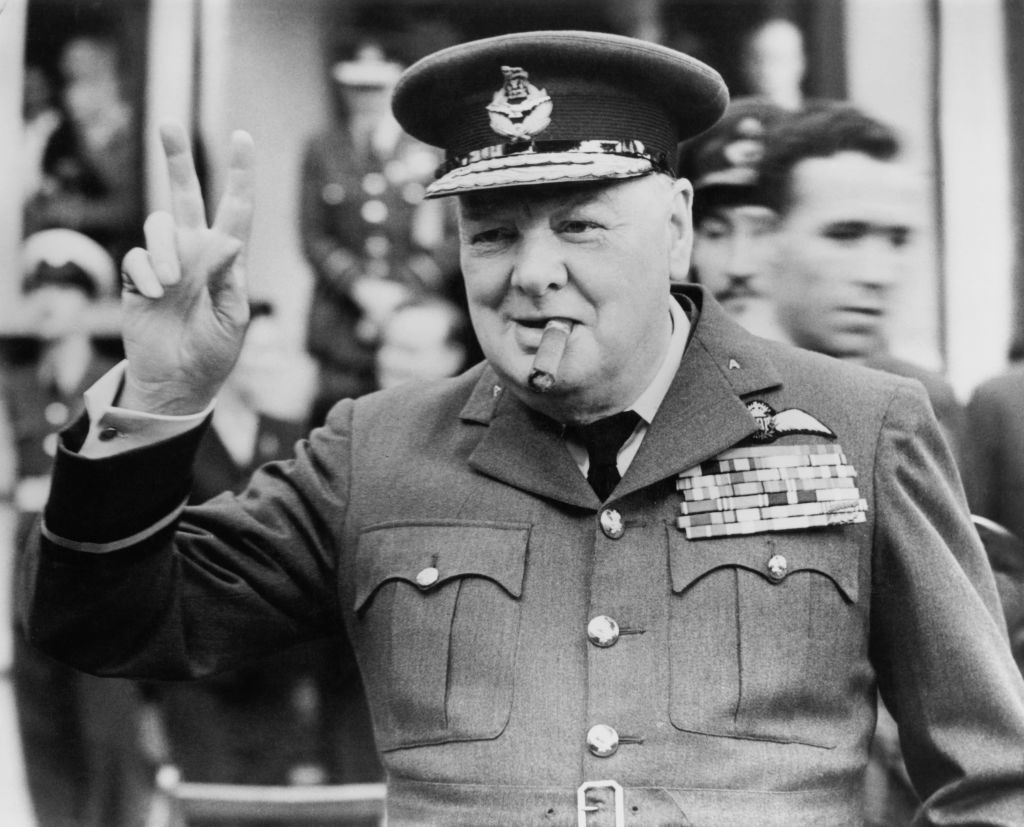 Winston Churchill (1874 - 1965) gives his famous v-sign as he opens the new headquarters of 615 (County of Surrey) Squadron of the RAAF (Royal Auxiliary Air Force) at Croydon, 1948.