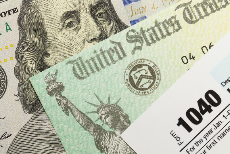 Federal Taxes. 1040 Tax Form with Refund Check and Cash.