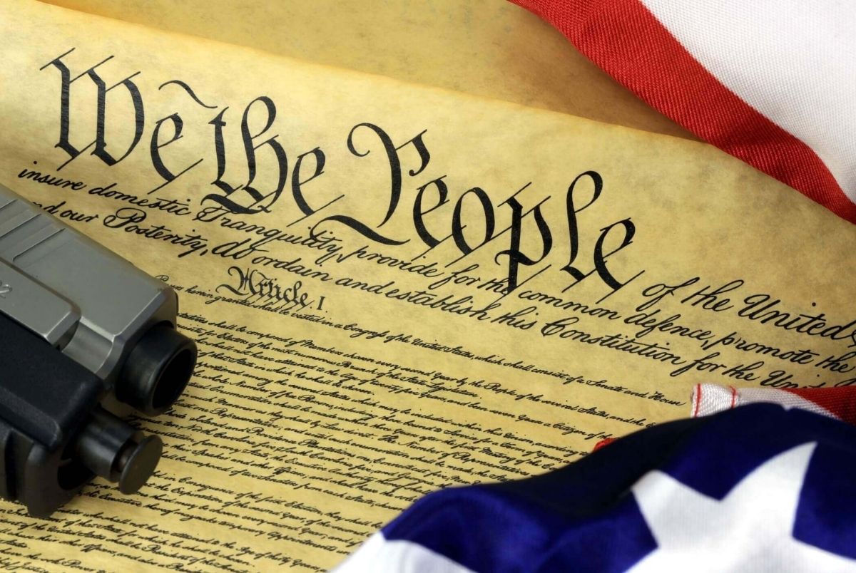 US Constitution - We The People with American Flag and Hand Gun. Constitution of the United States and American Flag, We The People with hand gun