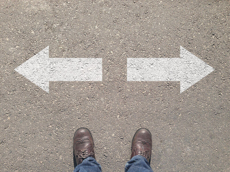 Standing at the crossroad making decision which way to go - easy or hard