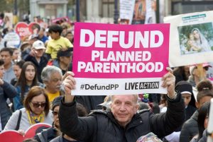 Participants in the annual March for Life in San Francisco, California. San Francisco, CA - Jan 25, 2025: Unidentified participants in the annual March for Life, holding pro-life signs and banners, walking down Market street towards the Embarcadero