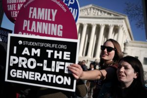 WASHINGTON, DC - JANUARY 19: A pro-life activist tries to block the signs of pro-choice activists in front of the the U.S. Supreme Court during the 2018 March for Life January 19, 2018 in Washington, DC. Activists gathered in the nation's capital for the annual event to mark the anniversary of the Supreme Court Roe v. Wade ruling that legalized abortion in 1973. (Photo by Alex Wong/Getty Images)