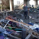 California Governor Gavin Newsom works with Caltrans in removing debris at a long-standing homeless encampment along Highway 80 on August 9, 2021 in Berkeley, California.
