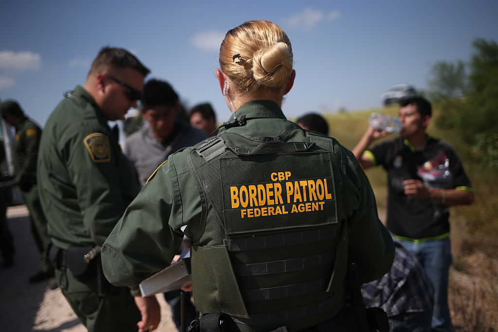 U.S. Border Patrol agents detain undocumented immigrants after they crossed the border from Mexico into the United States on August 7, 2015 in McAllen, Texas.