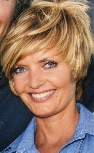 Florence Henderson wearing a blue denim shirt.