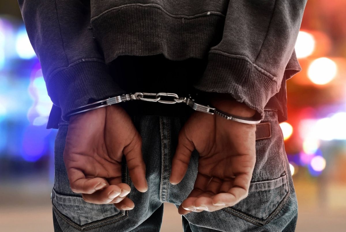 Male in handcuffs on bokeh background