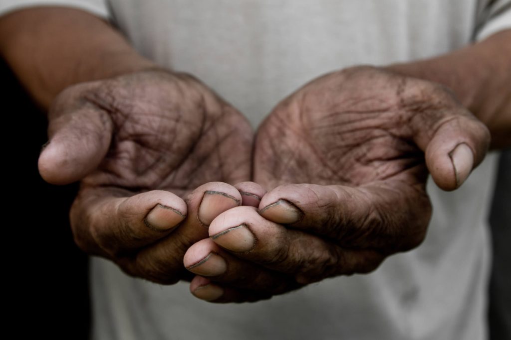 The poor old man`s hands beg you for help. The concept of hunger or poverty. Selective focus. Poverty in retirement. Alms