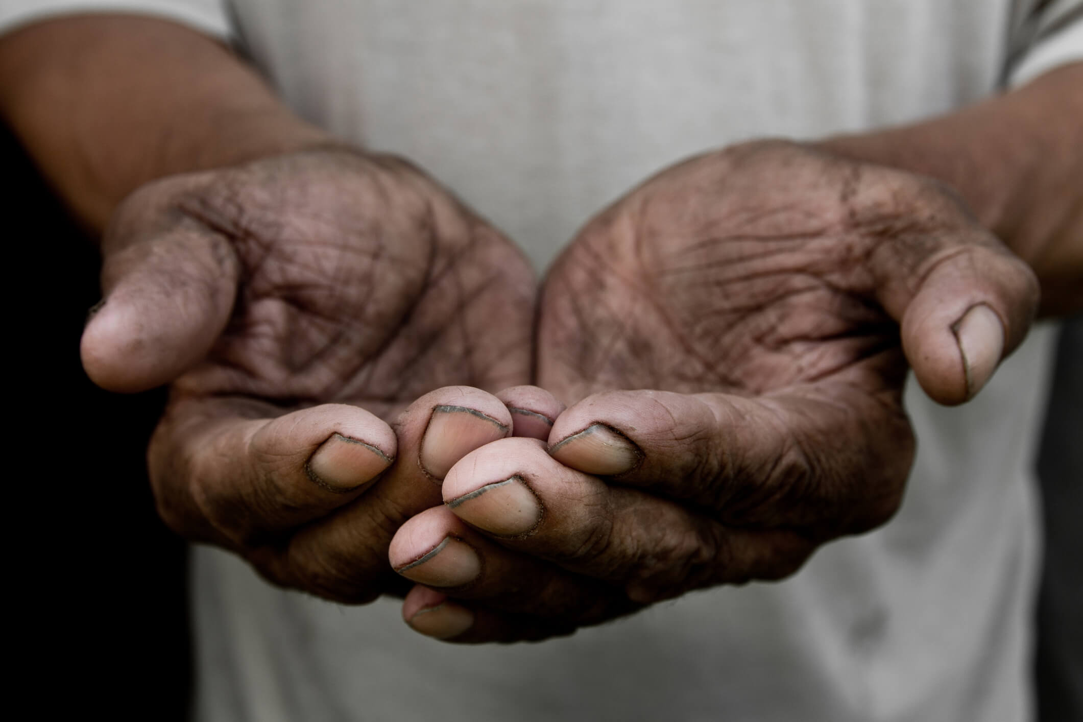 The poor old man`s hands beg you for help. The concept of hunger or poverty. Selective focus. Poverty in retirement. Alms