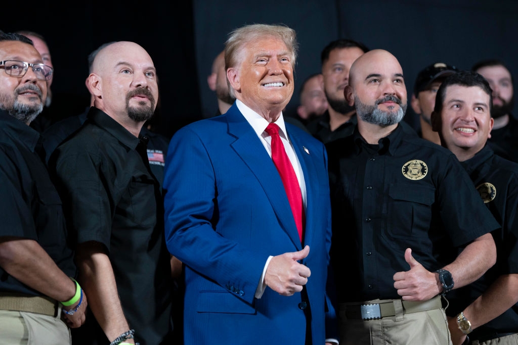 U.S. Republican presidential nominee, former President Donald Trump poses for a picture with the National Border Patrol Council during a campaign rally at Findlay Toyota Center on October 13, 2024 in Prescott Valley, Arizona.